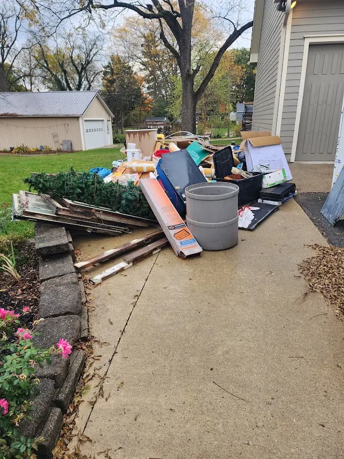 Dumpster being loaded with debris for Estate Cleanout Dumpster Rental in Belleville